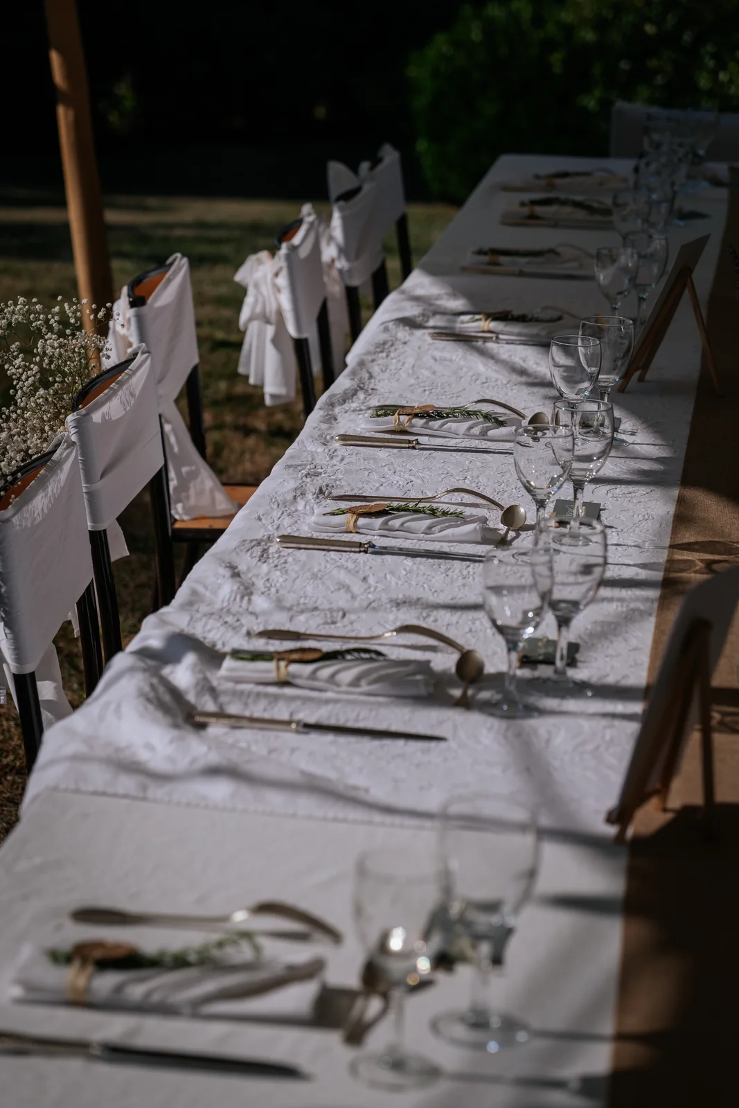 Une longue table de réception dressée avec soin attend les invités.